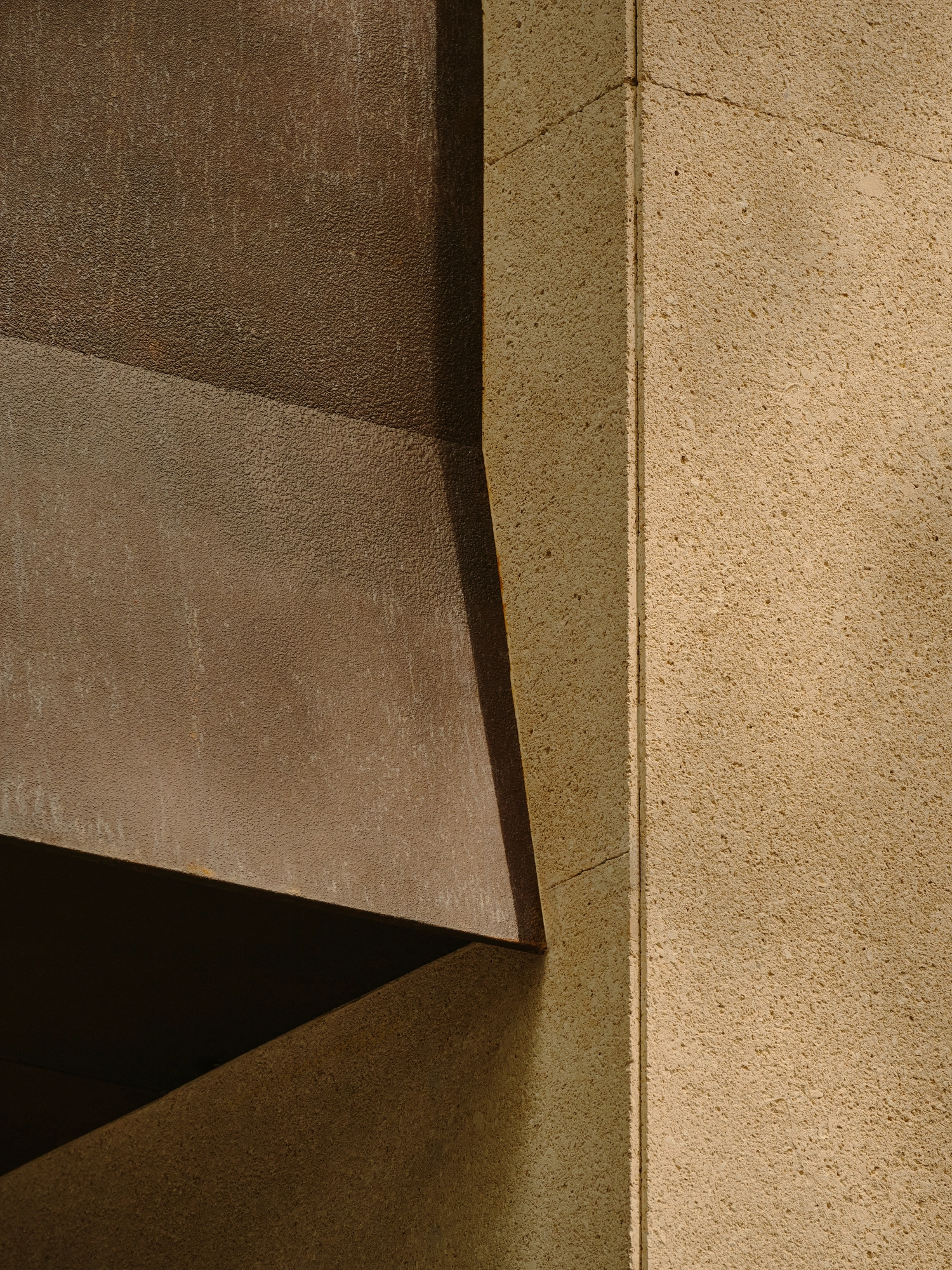 Conceived by Cotemp by ONOAA STUDIO, photographed by Jonathan Leijonhufvud — A close detail where the rusted iron canopy meets the pale mineral-rendered wall.