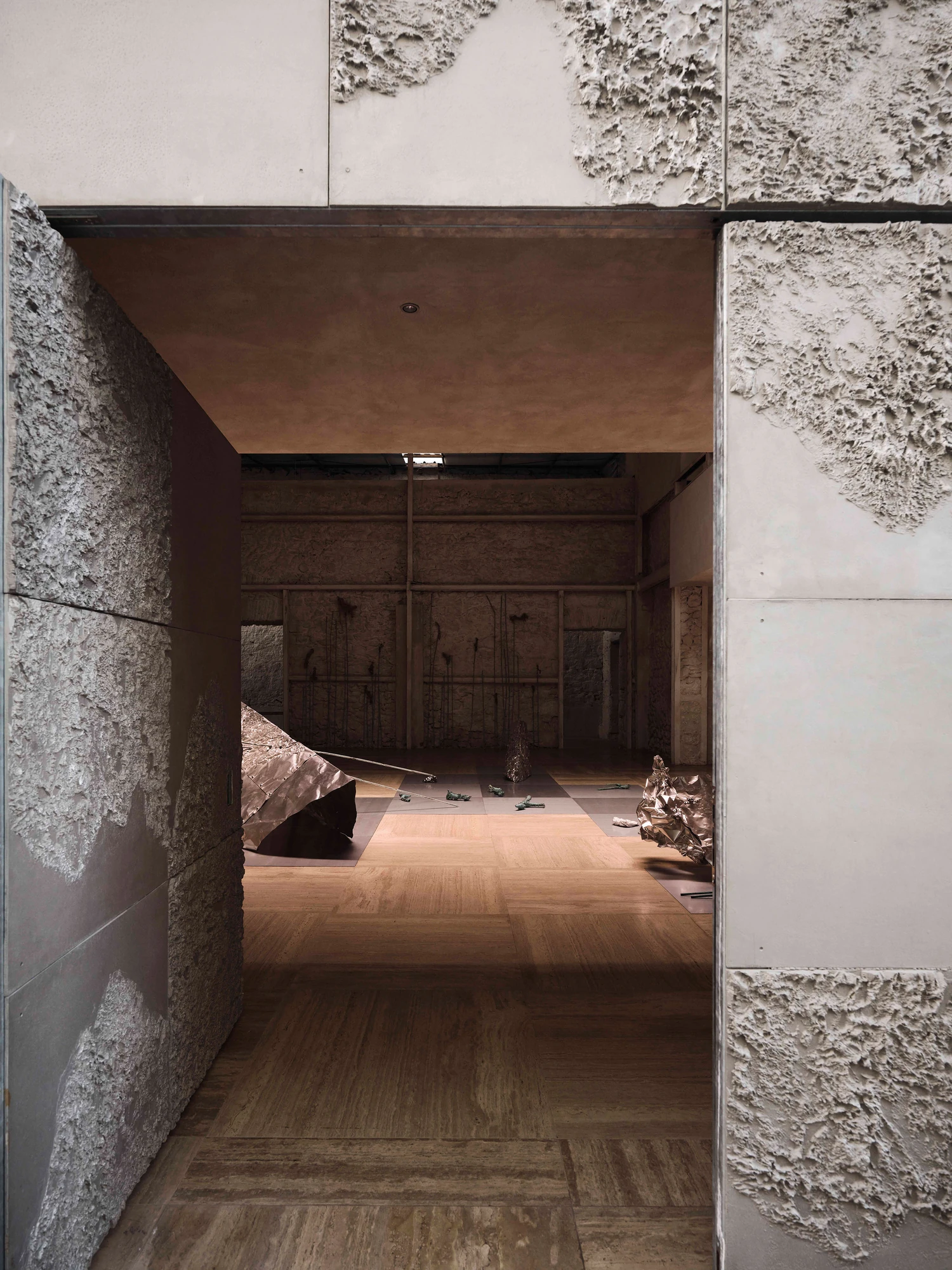 Castor Place by MPNYC, photographed by Yiorgos Kaplanidis — Installation view of Casting Water by Stefania Strouza, framed through a stone opening into the hall
