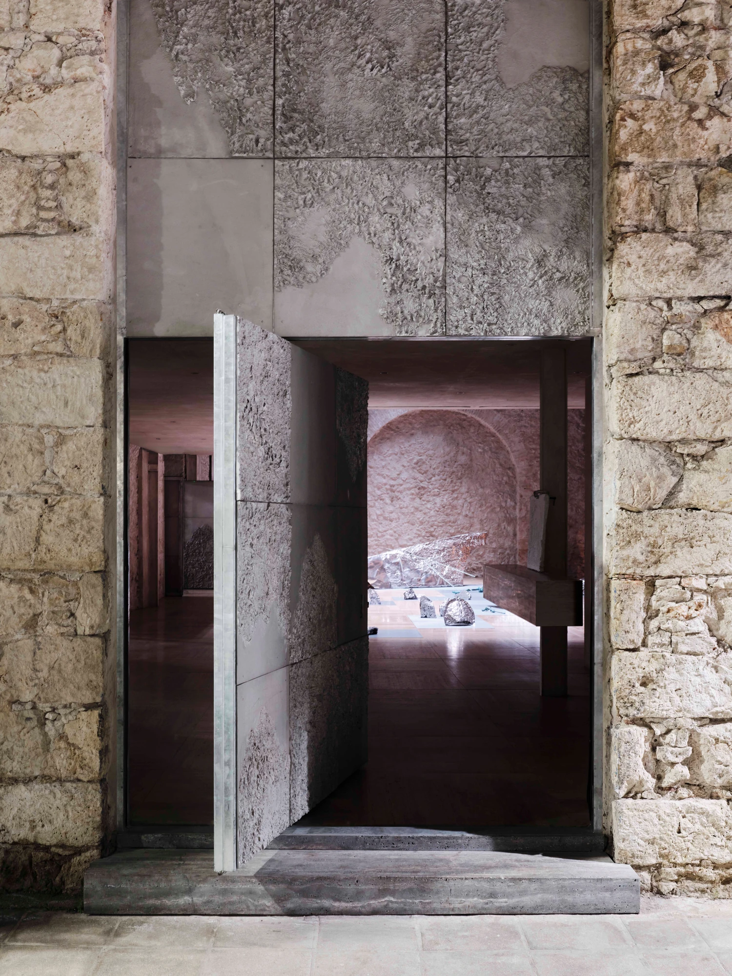 Castor Place by MPNYC, photographed by Yiorgos Kaplanidis — Installation view of Casting Water by Stefania Strouza, seen through the open cast aluminium door into the hall