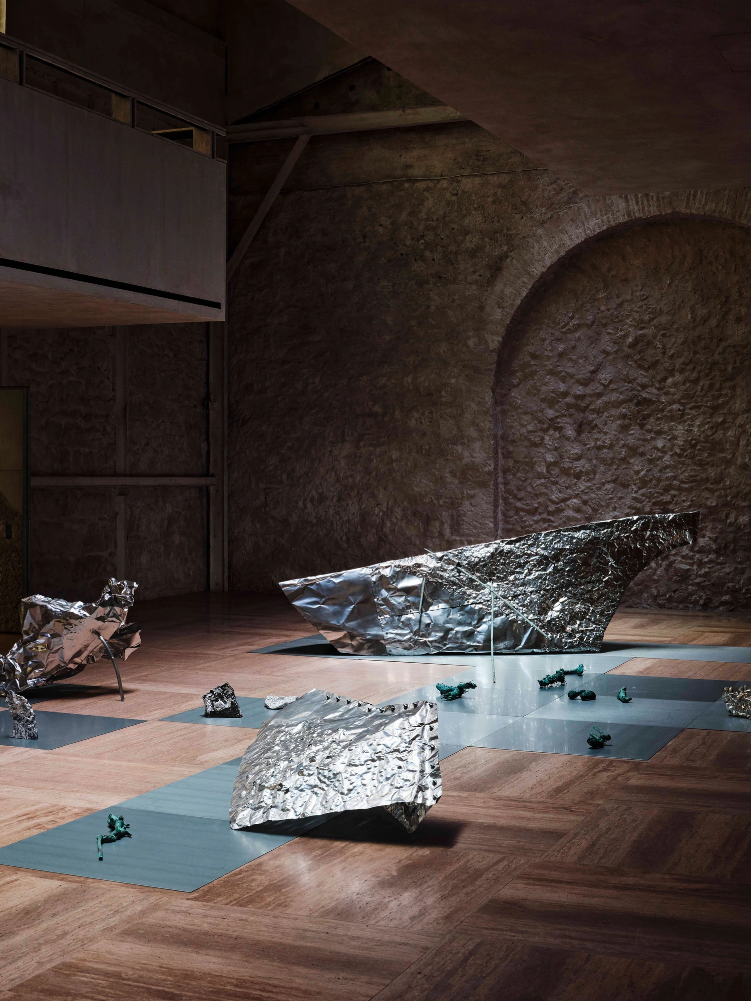 Castor Place by MPNYC, photographed by Yiorgos Kaplanidis — Installation view of Casting Water by Stefania Strouza, aluminium works on the hall floor against the stone wall