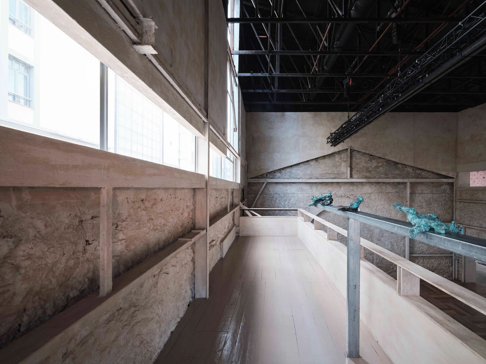 Castor Place by MPNYC, photographed by Yiorgos Kaplanidis — Installation view of Casting Water by Stefania Strouza, aluminium works along a mezzanine beam under the trusses