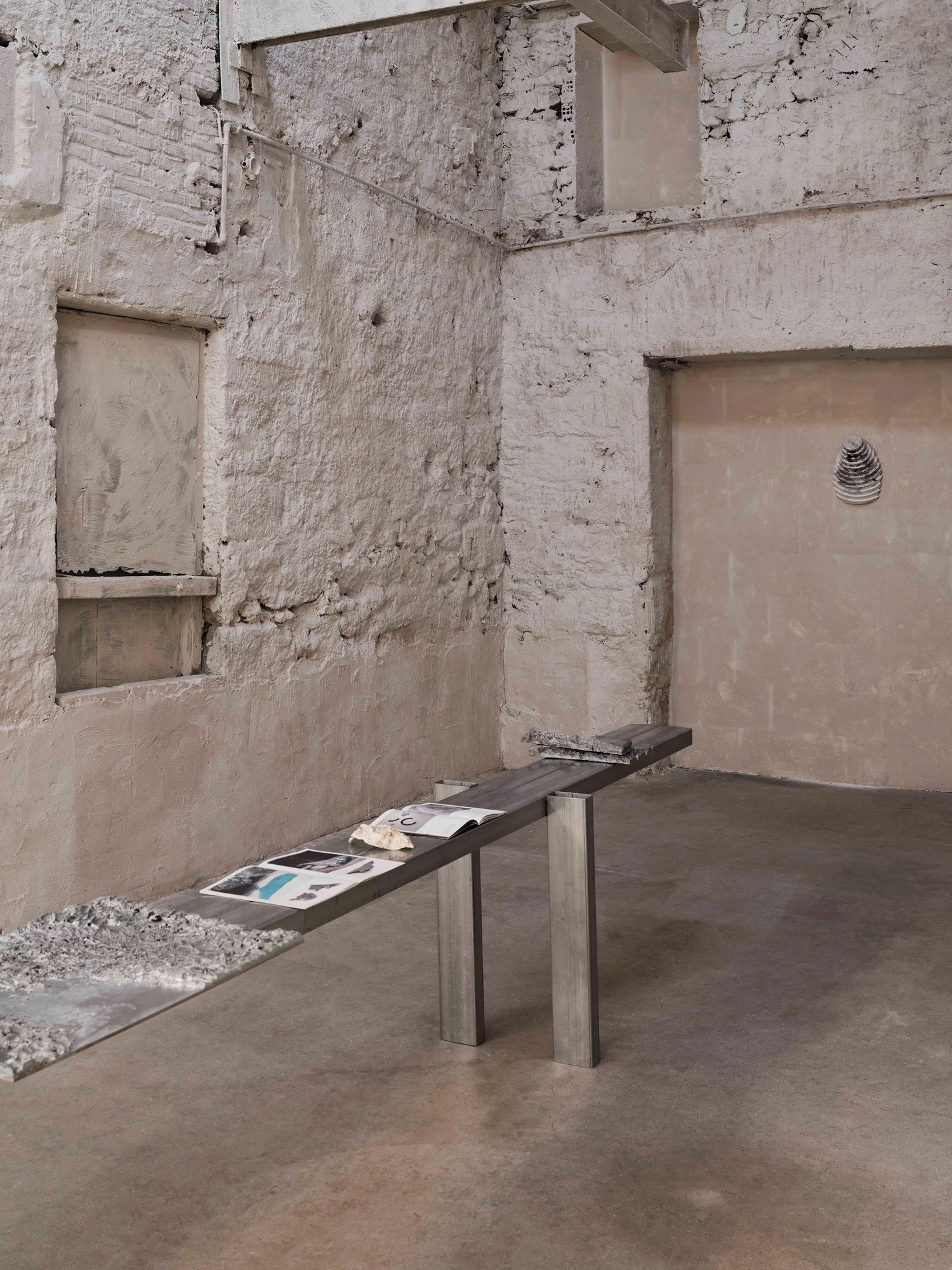 Castor Place by MPNYC, photographed by Yiorgos Kaplanidis — Installation view of Casting Water by Stefania Strouza in a lime stucco room with a blocked window