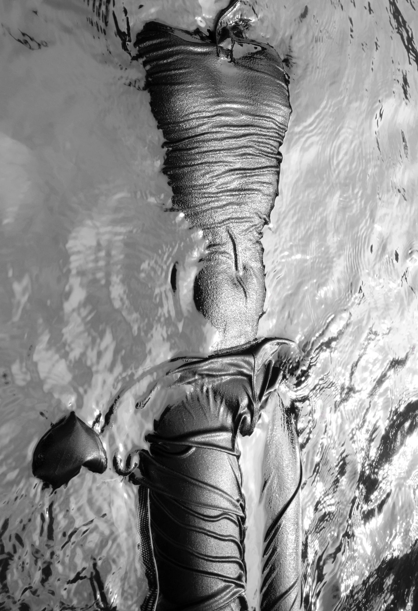 Down by the Hudson by Caleb Stein, photographed by Caleb Stein — Statue in Water (2020), sodden clothing clinging and folding on a body half-submerged in bright moving water