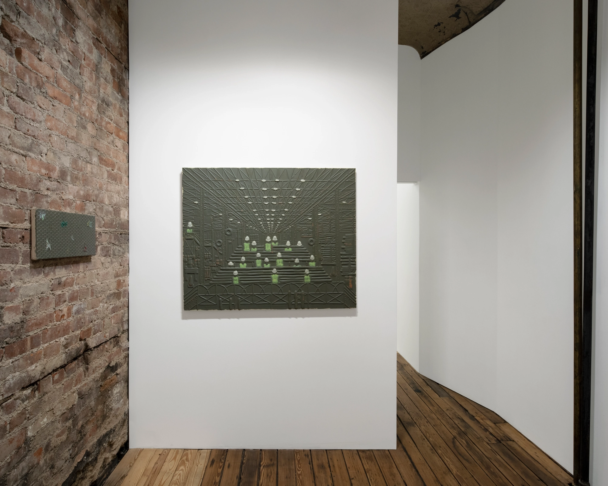 USA Flowers by Michael Assiff — USA Flowers at Post Times, New York, a dark relief on a white partition beside the bare brick.