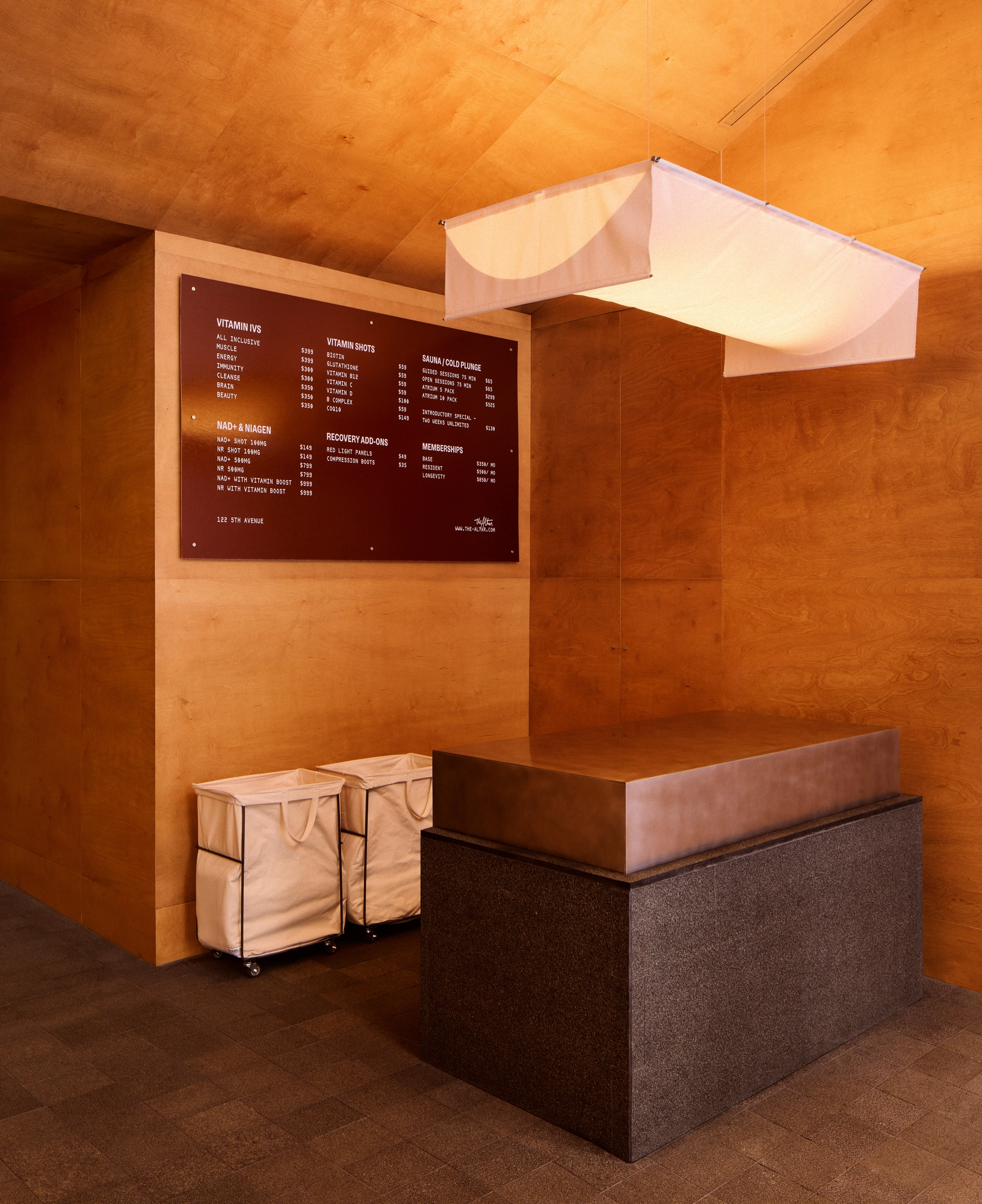 The Altar by MV-LLC — A counter in the wood-paneled reception, a board on the wall behind it.