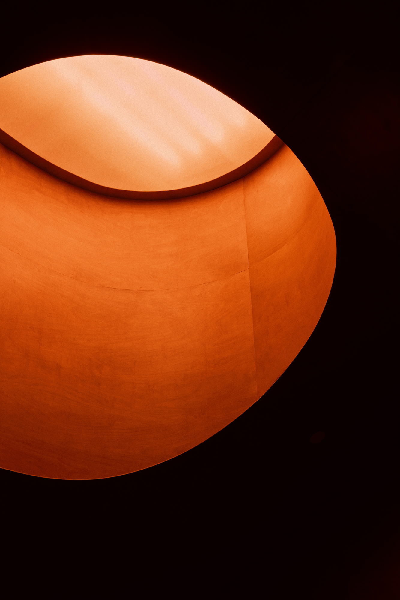 The Altar by MV-LLC — The large oculus over the stairwell, a glowing circular opening cut into wood paneling.