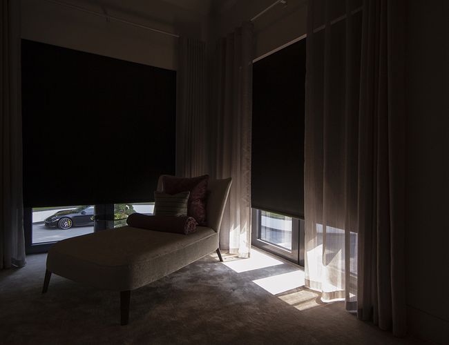 Close-up view of Blindspace roller blinds with side channels on windows and doors