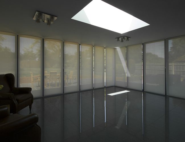 Close-up view of Blindspace roller blinds on corner windows