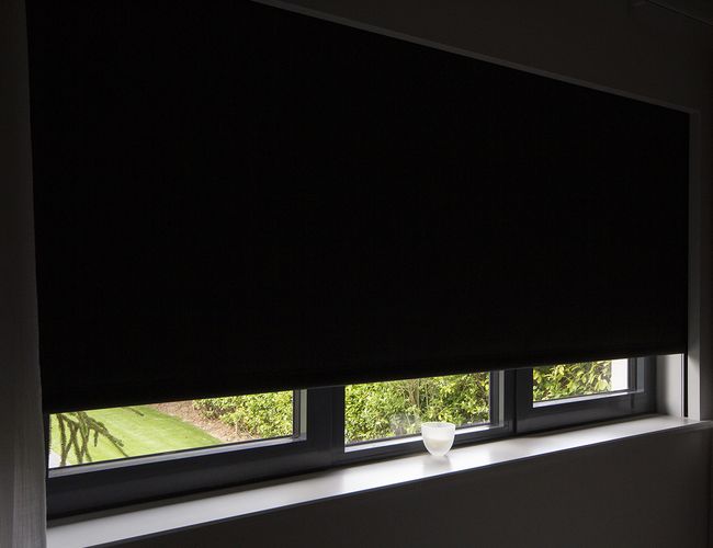 Close-up view of Blindspace roller blinds with side channels on windows and doors