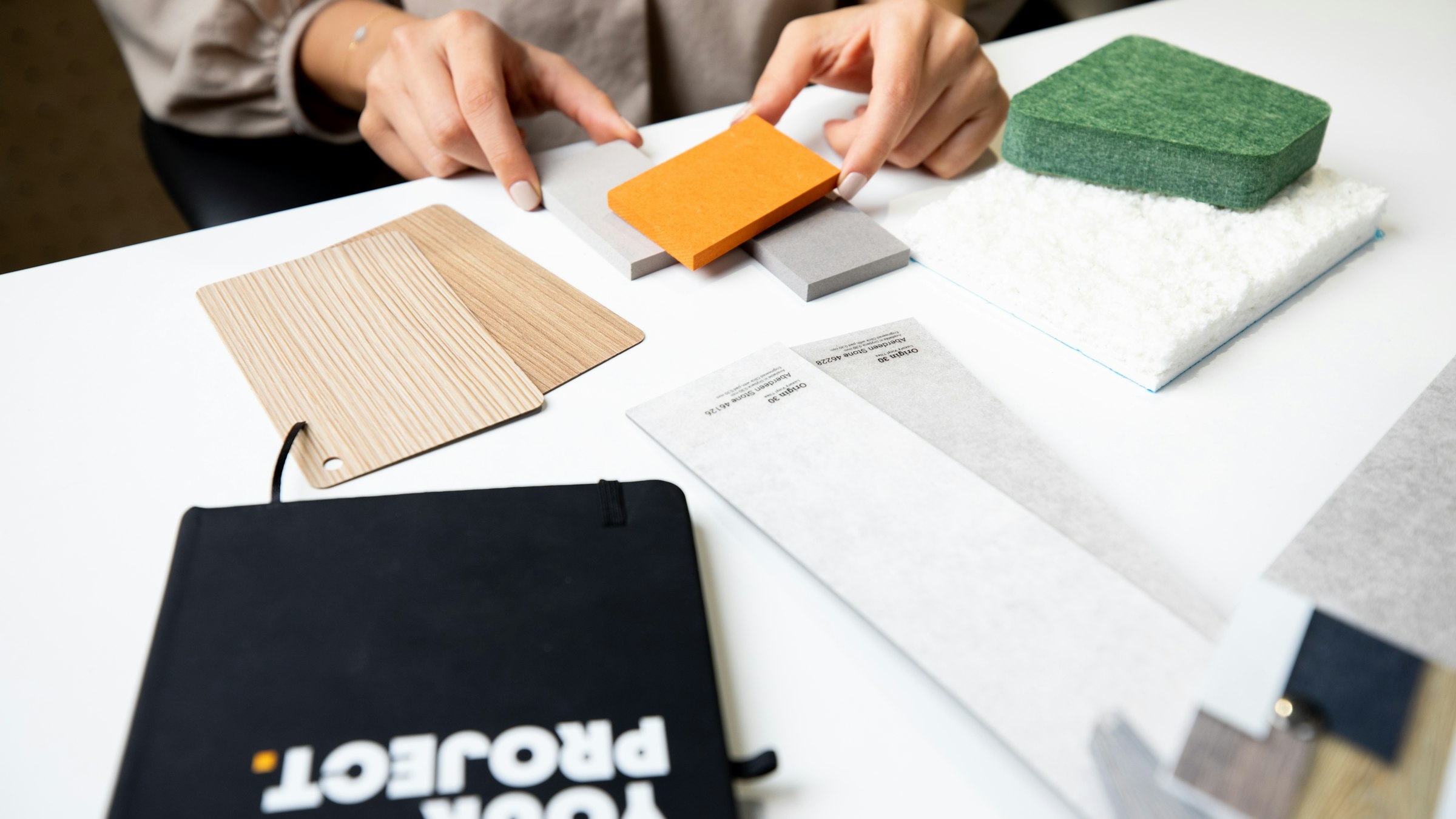 Designers arranging material samples on a table