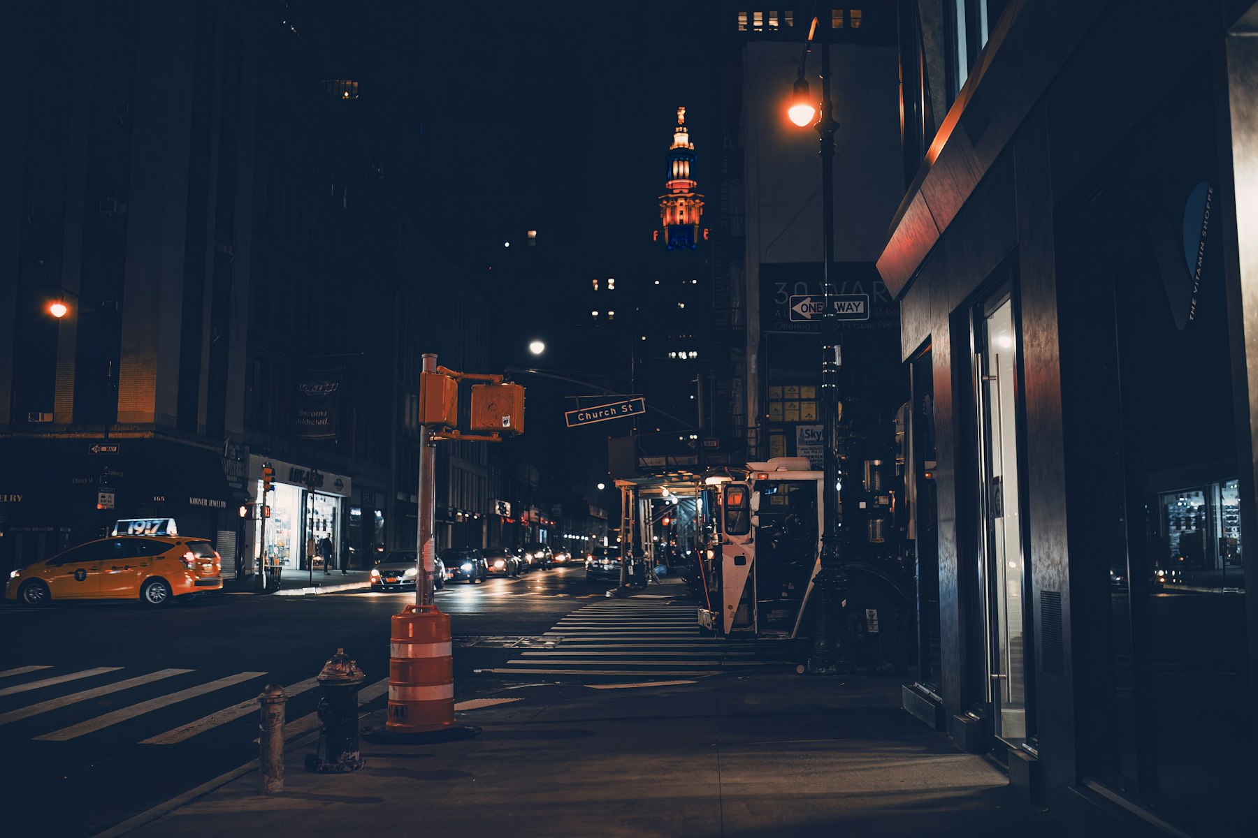 A city street at night with a traffic light