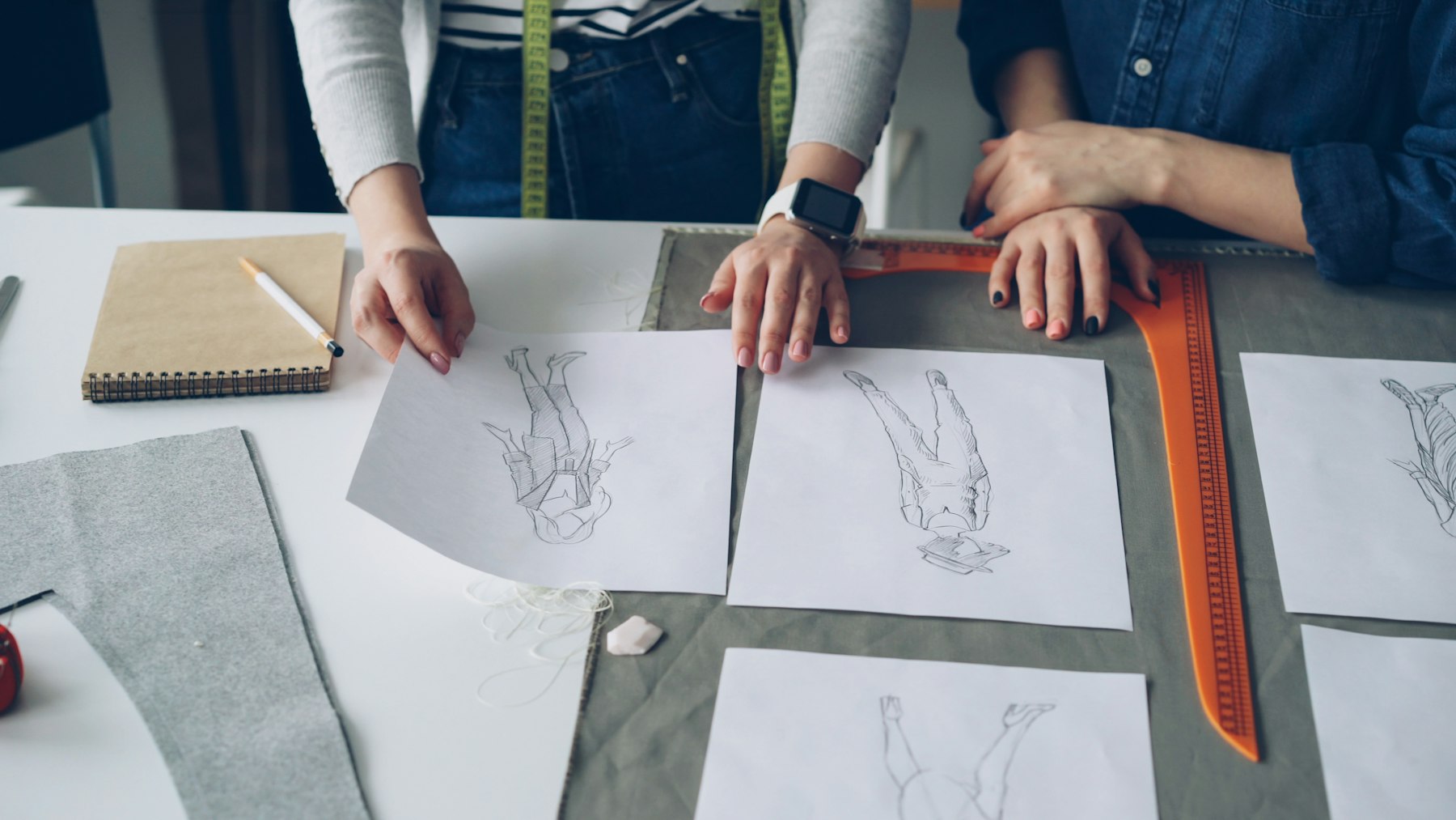 Designers looking at sketches and fabrics