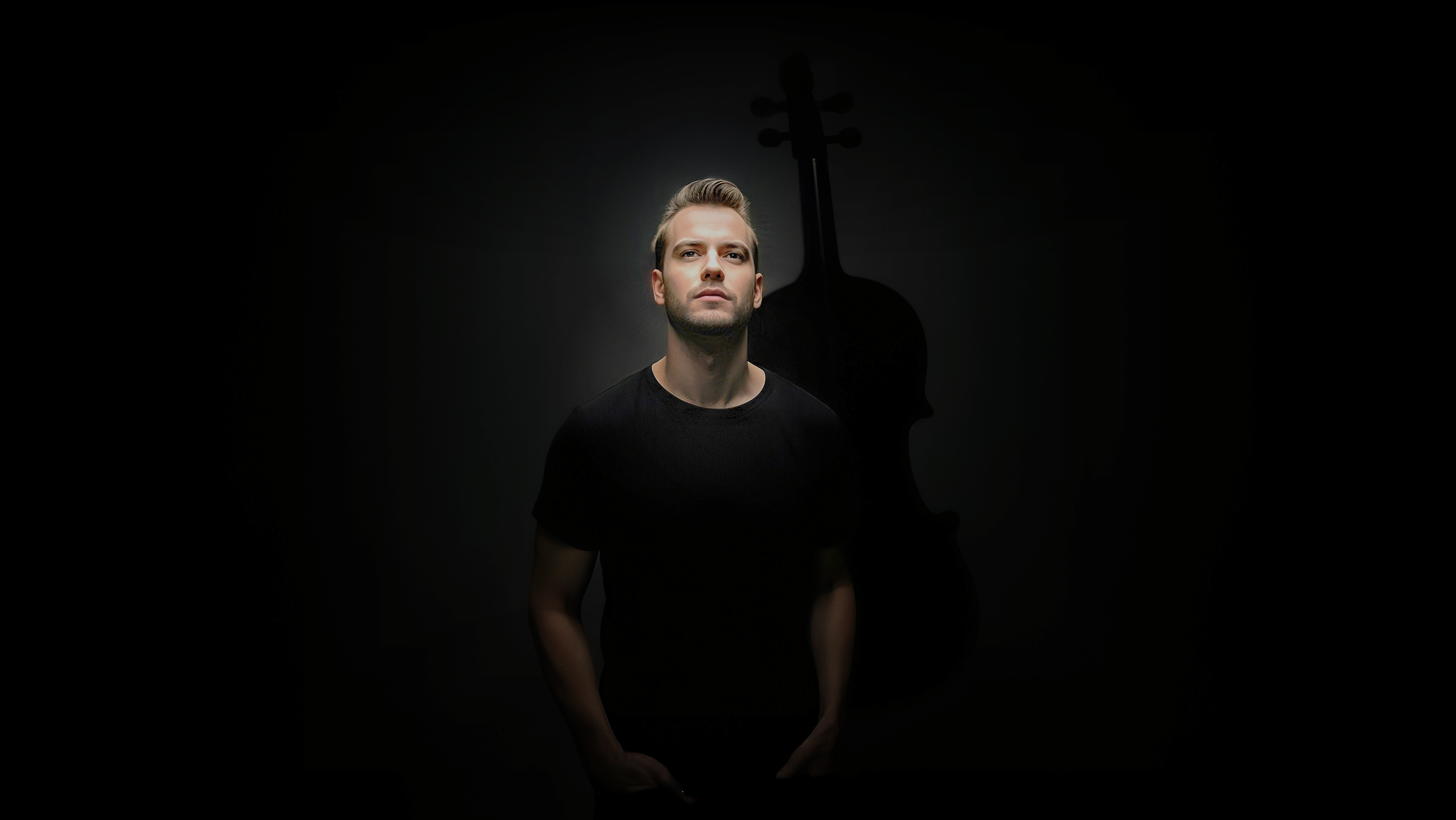 Valev Laube photographed against the shadow of a violin