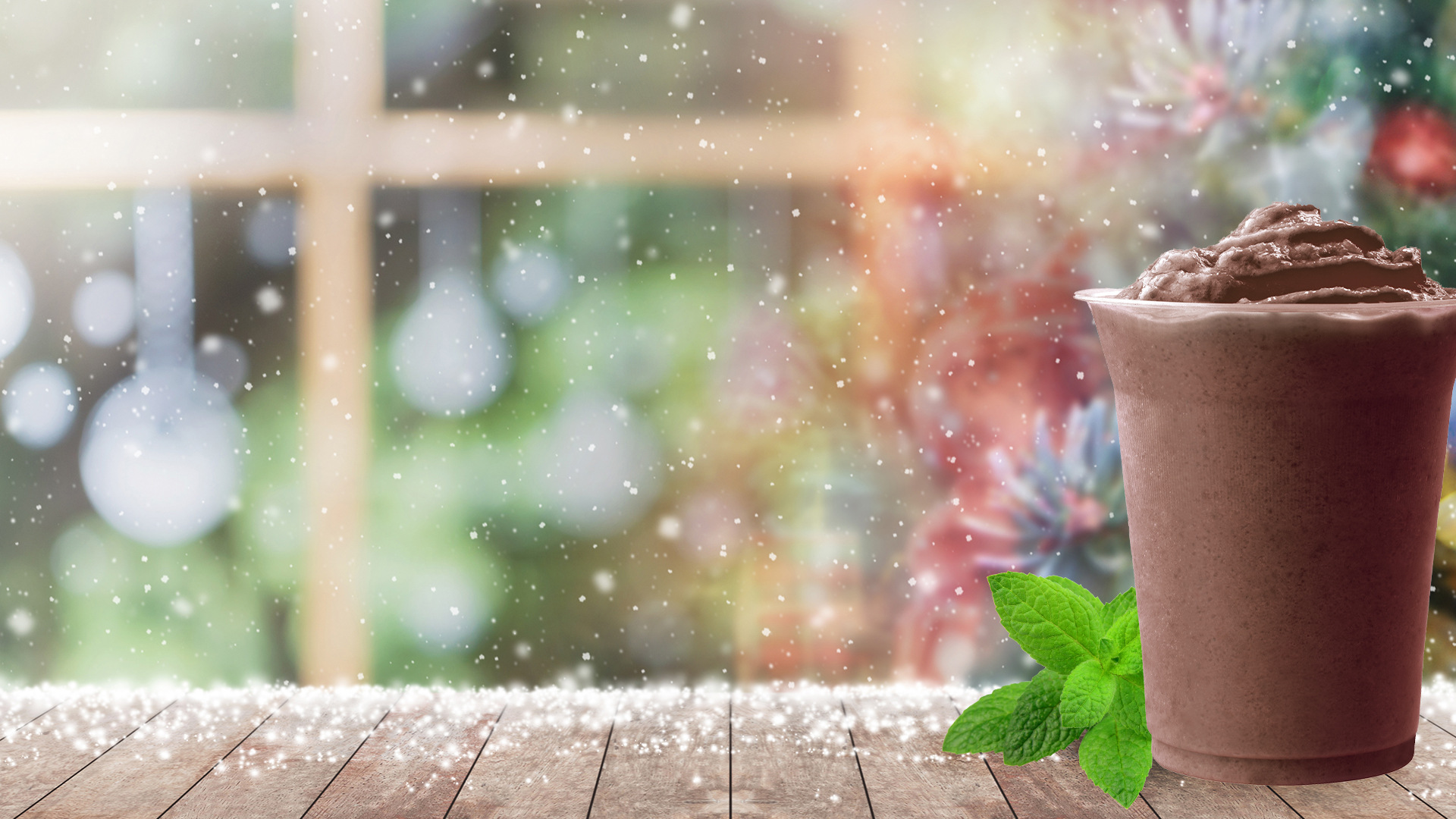 Peppermint Mocha Shake with Mint on a snowy wood counter top covered in snow