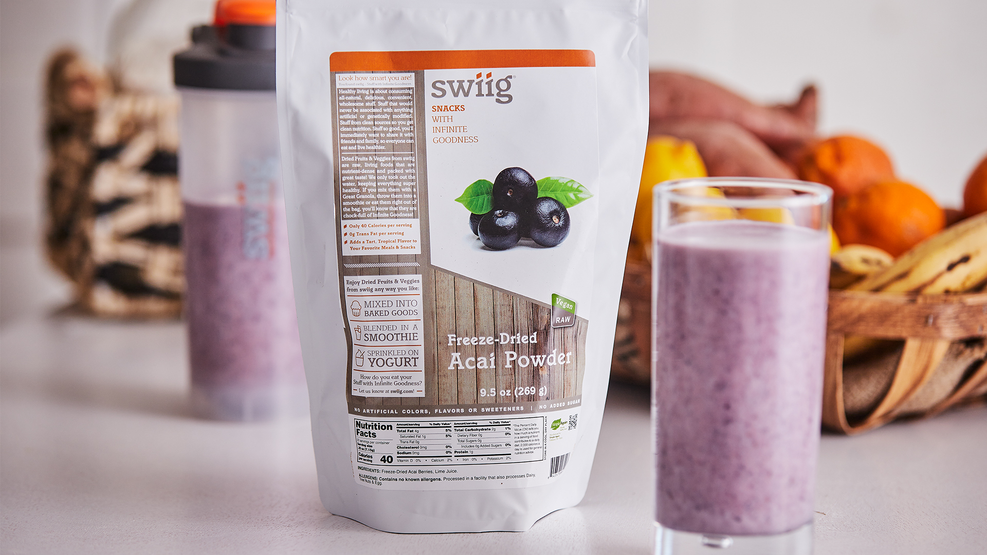 swiig freeze-dried acai powder bag on counter next to a purple acai protein shake