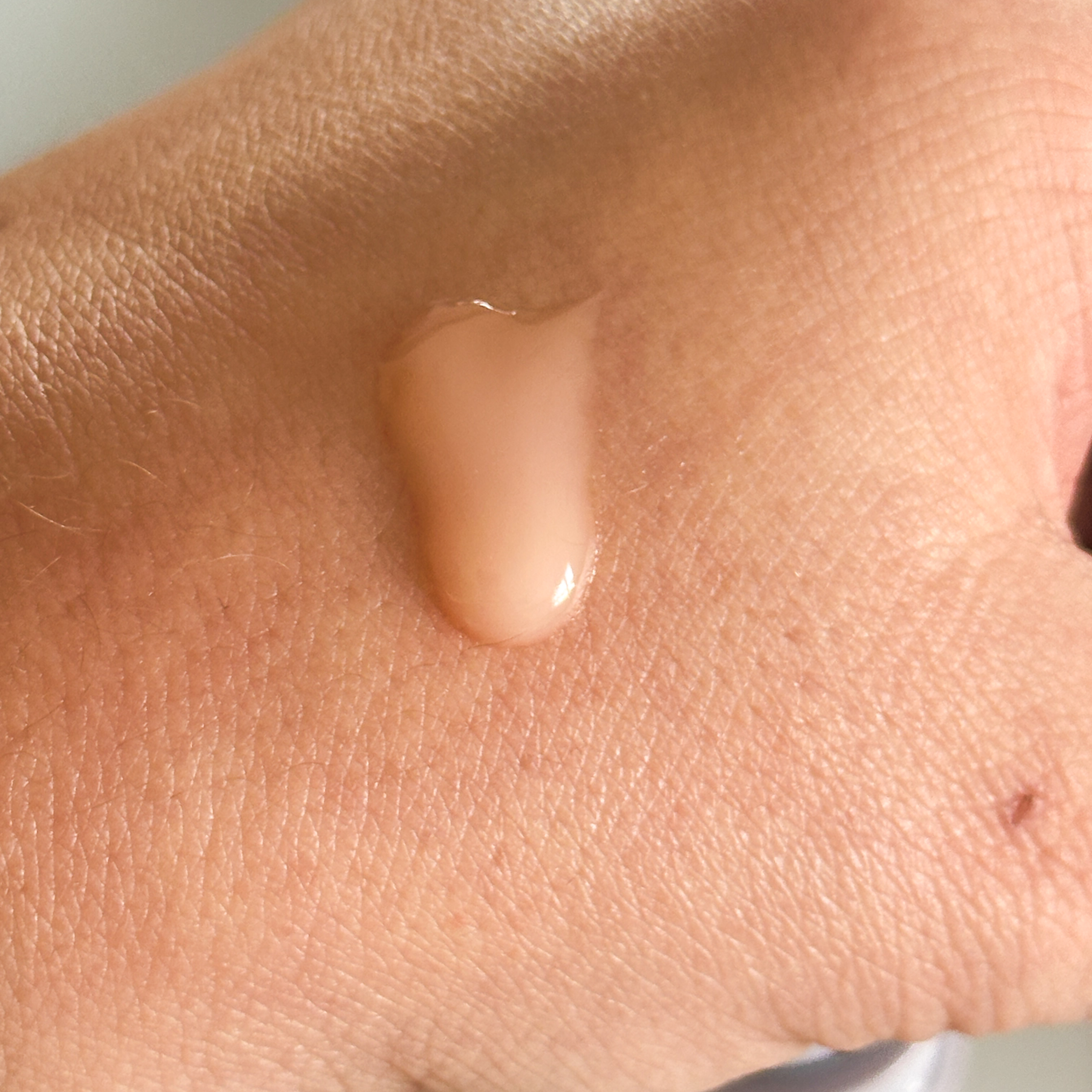The serum texture closeup shown on white skin tone 