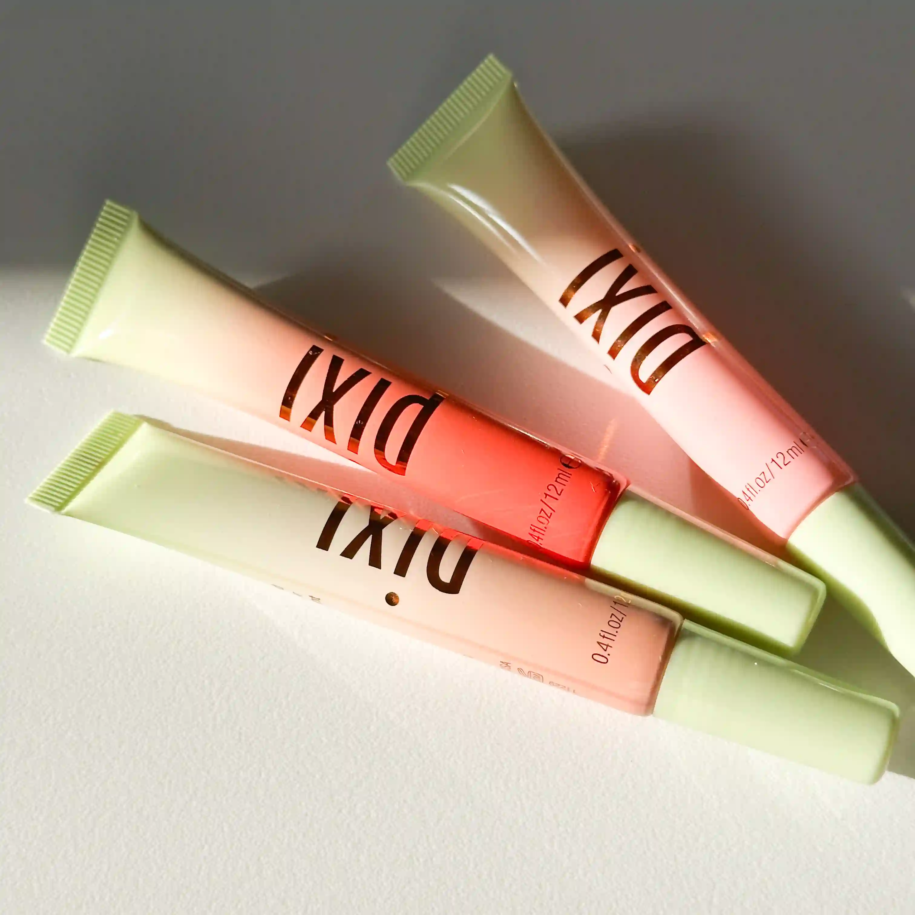 3 of the Pixi L:ipton Glosses laying flat on a white background