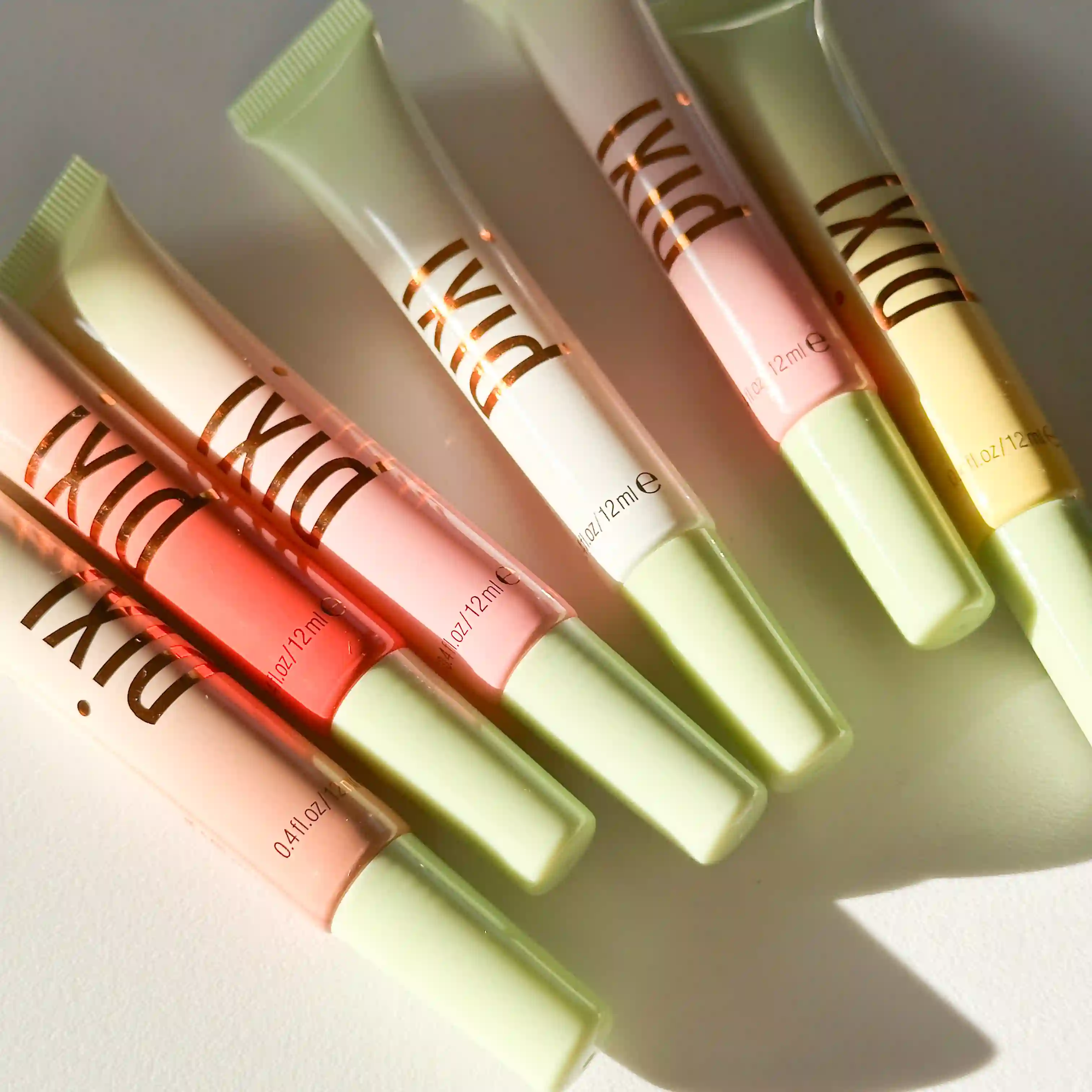 6 Pixi LipTone Glosses laying flat on a white background