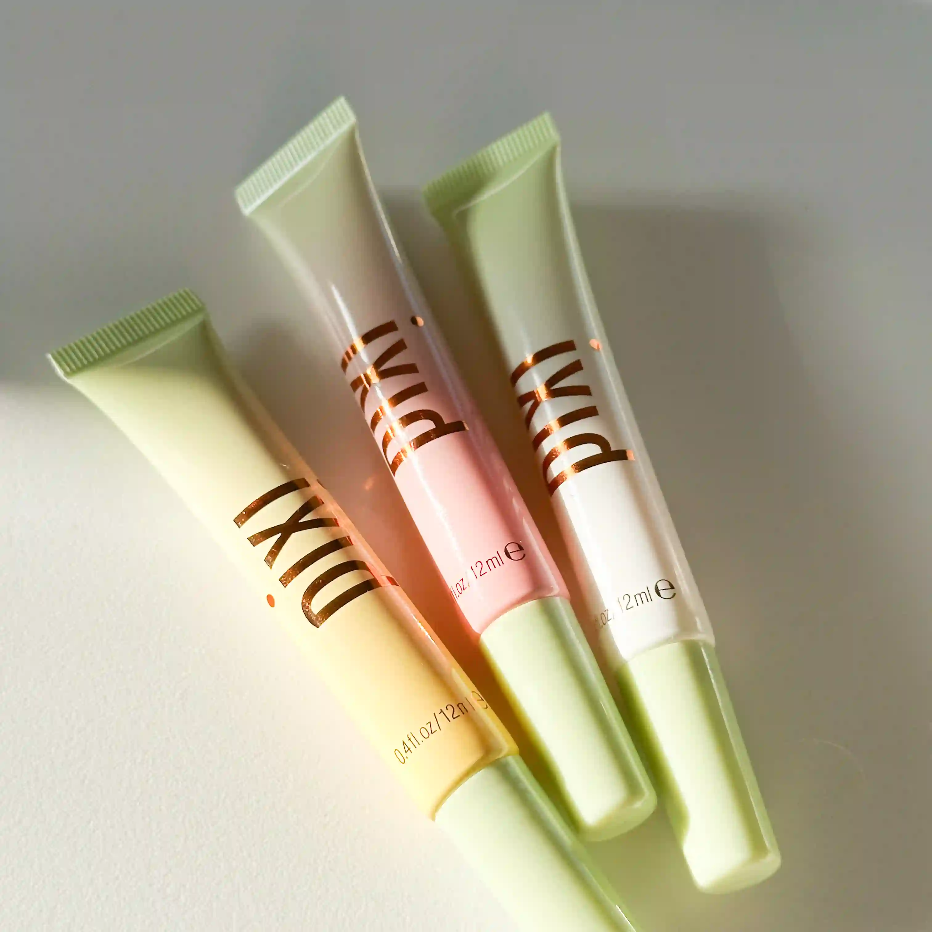 3 Pixi LipTone Glosses laying flat on a white background