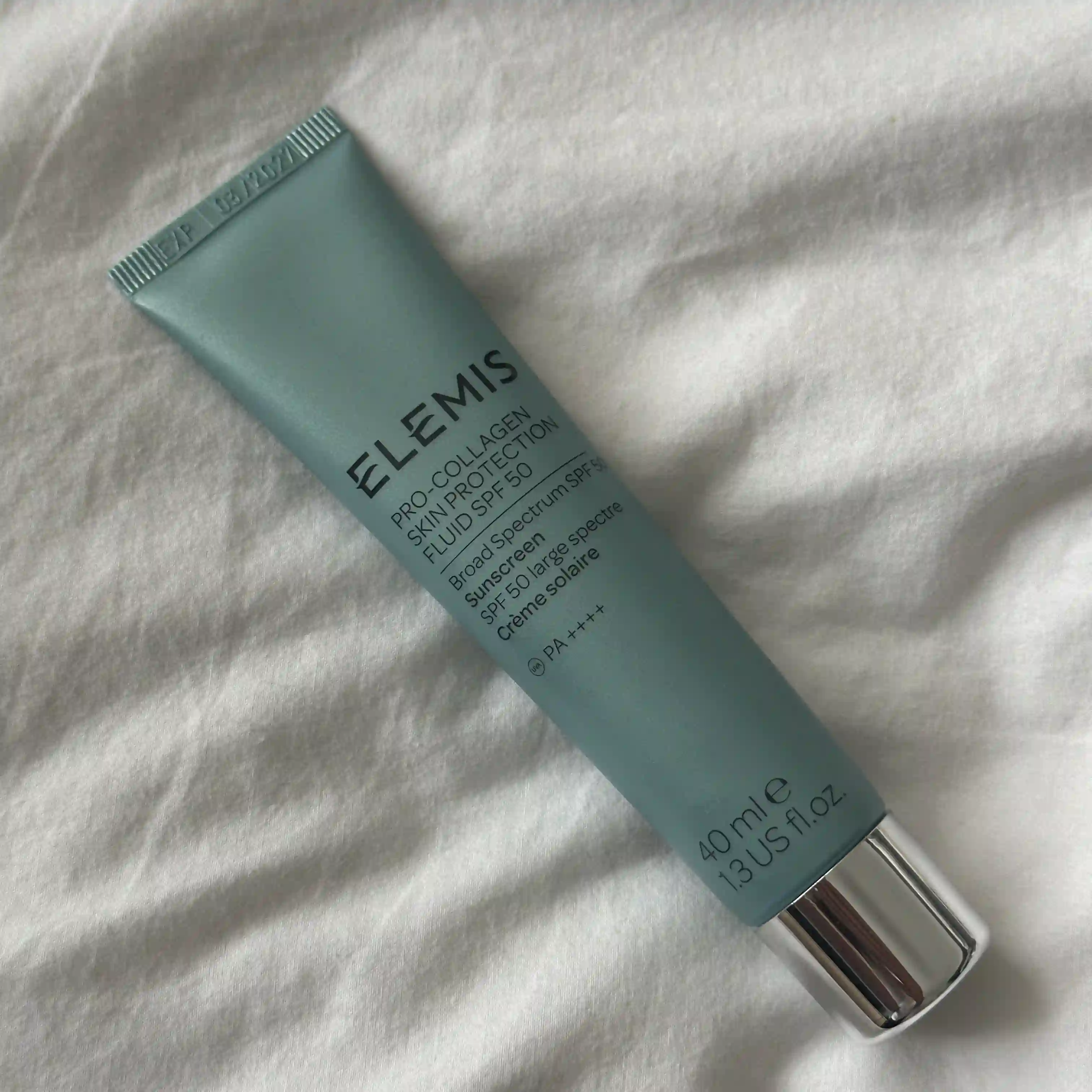 Image Elemis Pro Collagen Skin Protection Fluid SPF50 laying on a white sheet