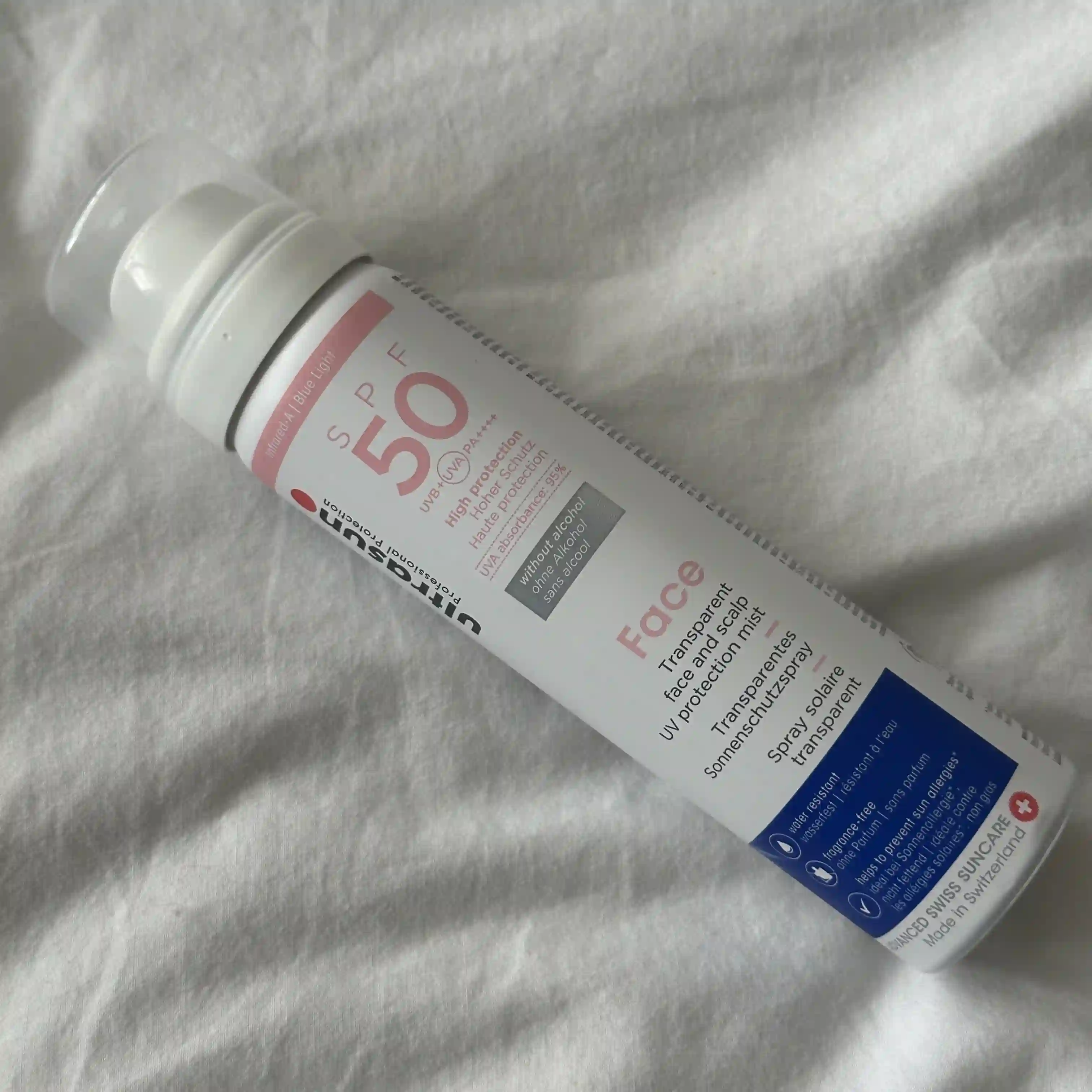 Photo of Ultrasun Transparent Face & Scalp Mist lying on a white sheet