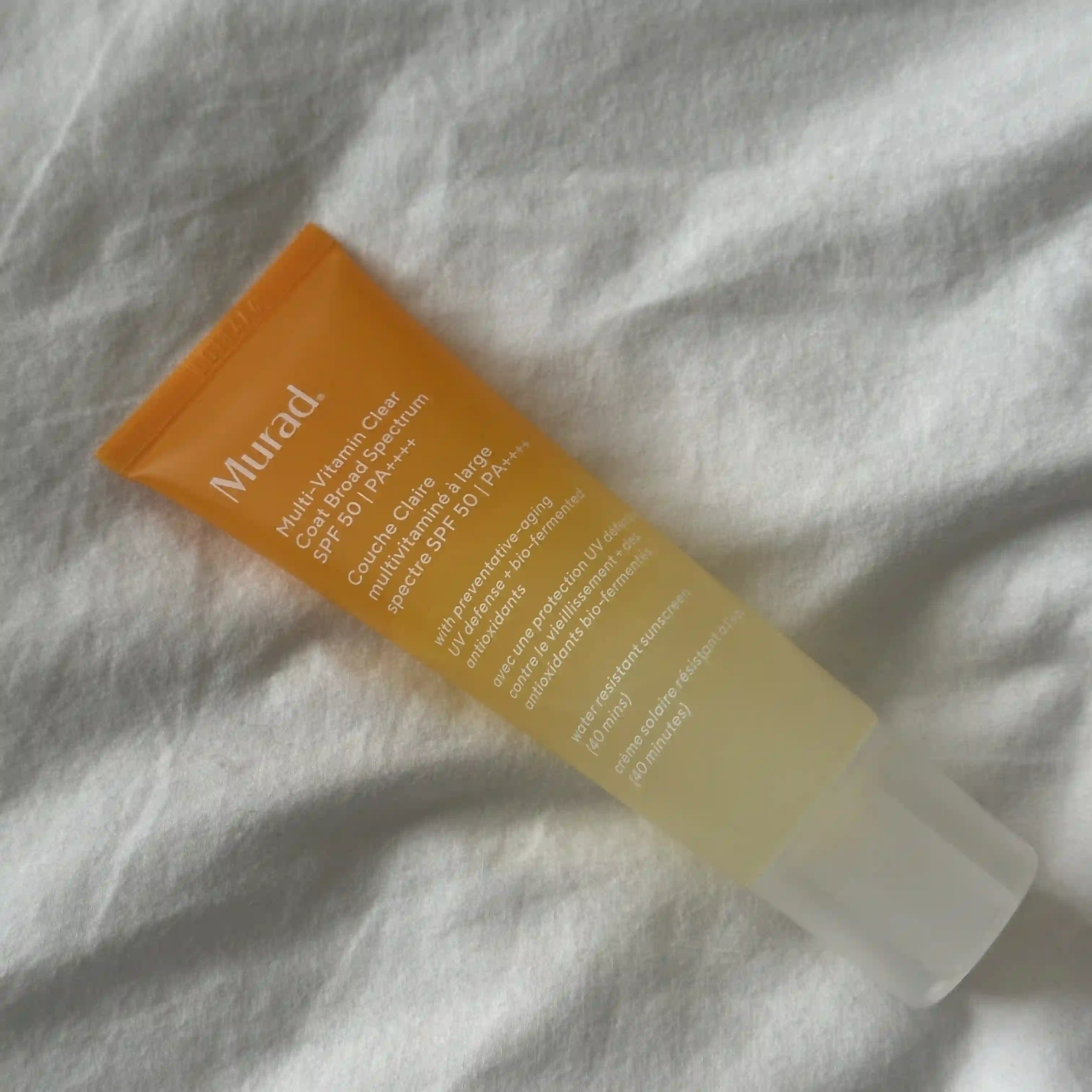 Image Murad Environmental Shield Multi Vitamin Clear Coat Broad Spectrum SPF laying on a white sheet