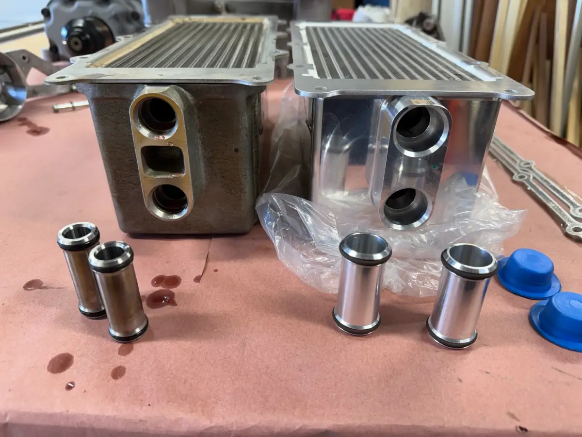 Stock GT500 intercooler brick on the left and VMP replacement on the right, with their different-sized coolant transfer tubes in front.