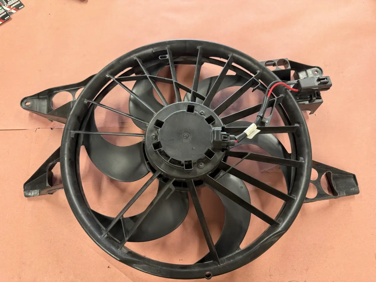 Factory GT500 cooling fan on a workbench after most of the surrounding plastic shroud was removed.