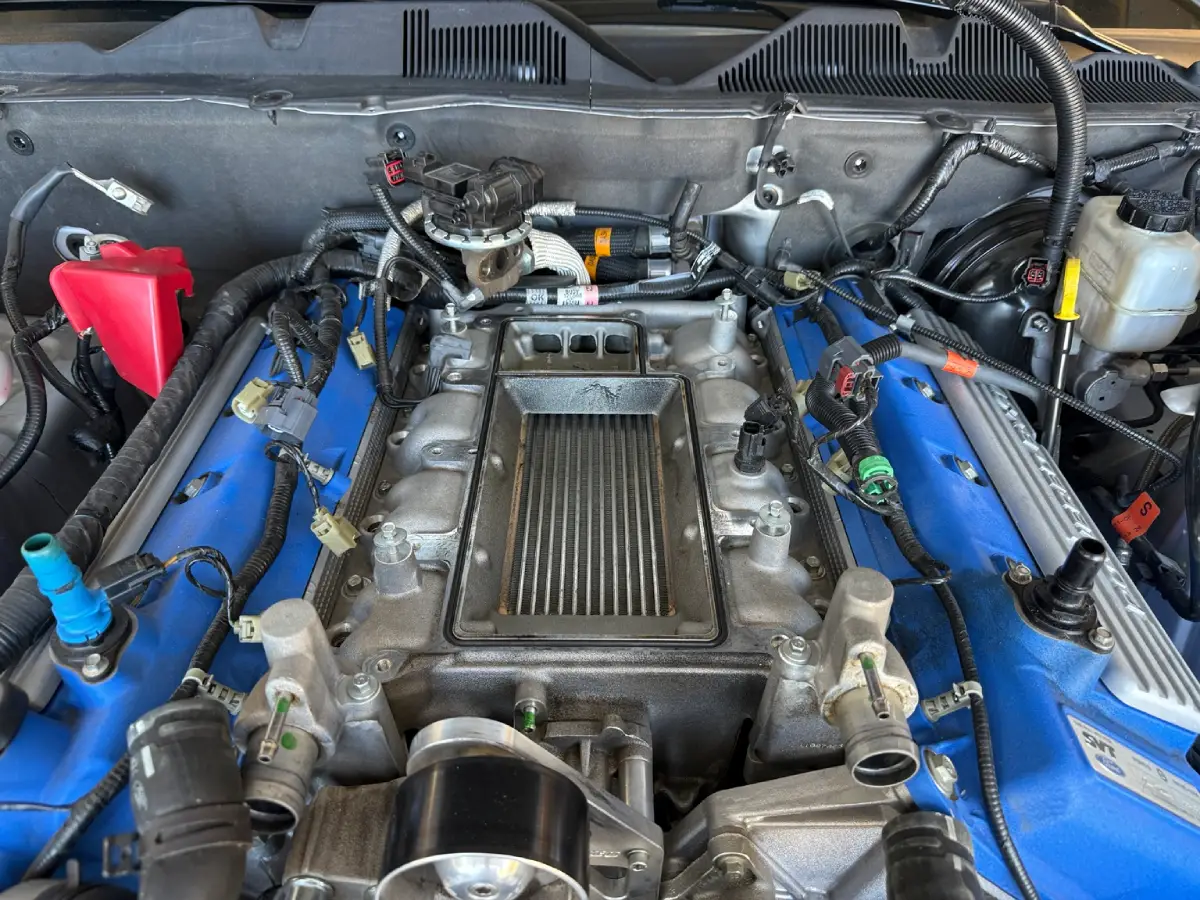 2012 GT500 engine with the supercharger removed and factory intercooler exposed in the lower intake manifold.
