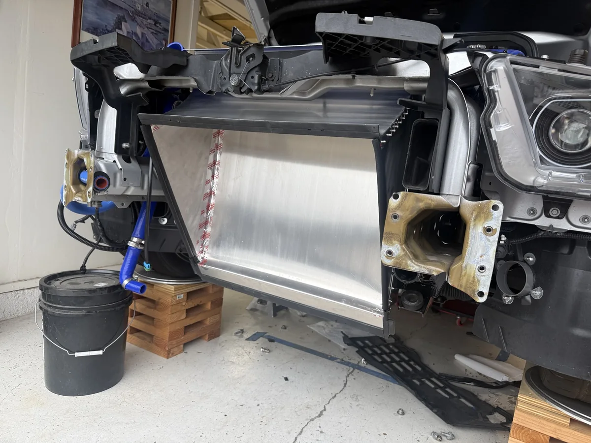 One-piece radiator outlet duct sitting in the GT500 with the front cooling components removed for access.