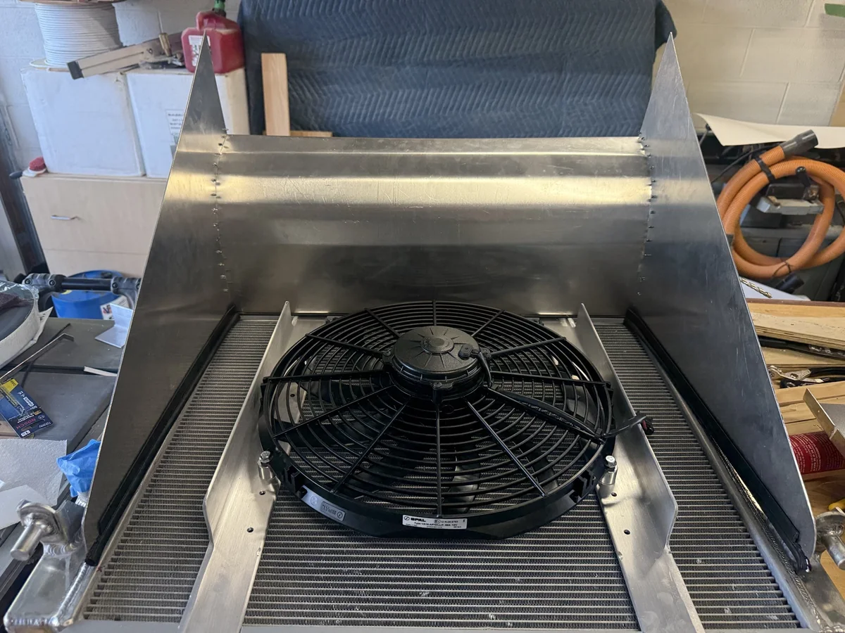 Slim SPAL fan on aluminum radiator brackets inside the partially assembled GT500 outlet duct.