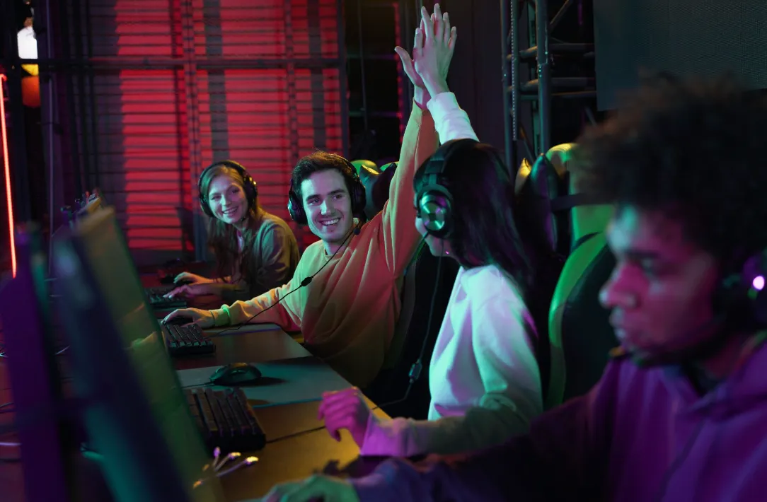 Rocket Science team members high-fiving at their gaming workstations
