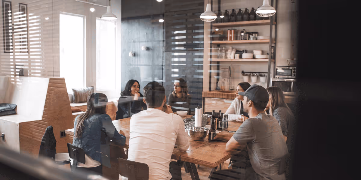 Anatta team members working together around a table in their office