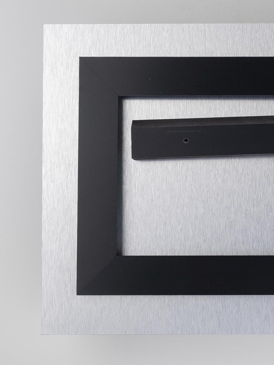 Back of an acrylic print showing the black inset float mount and aluminum backing