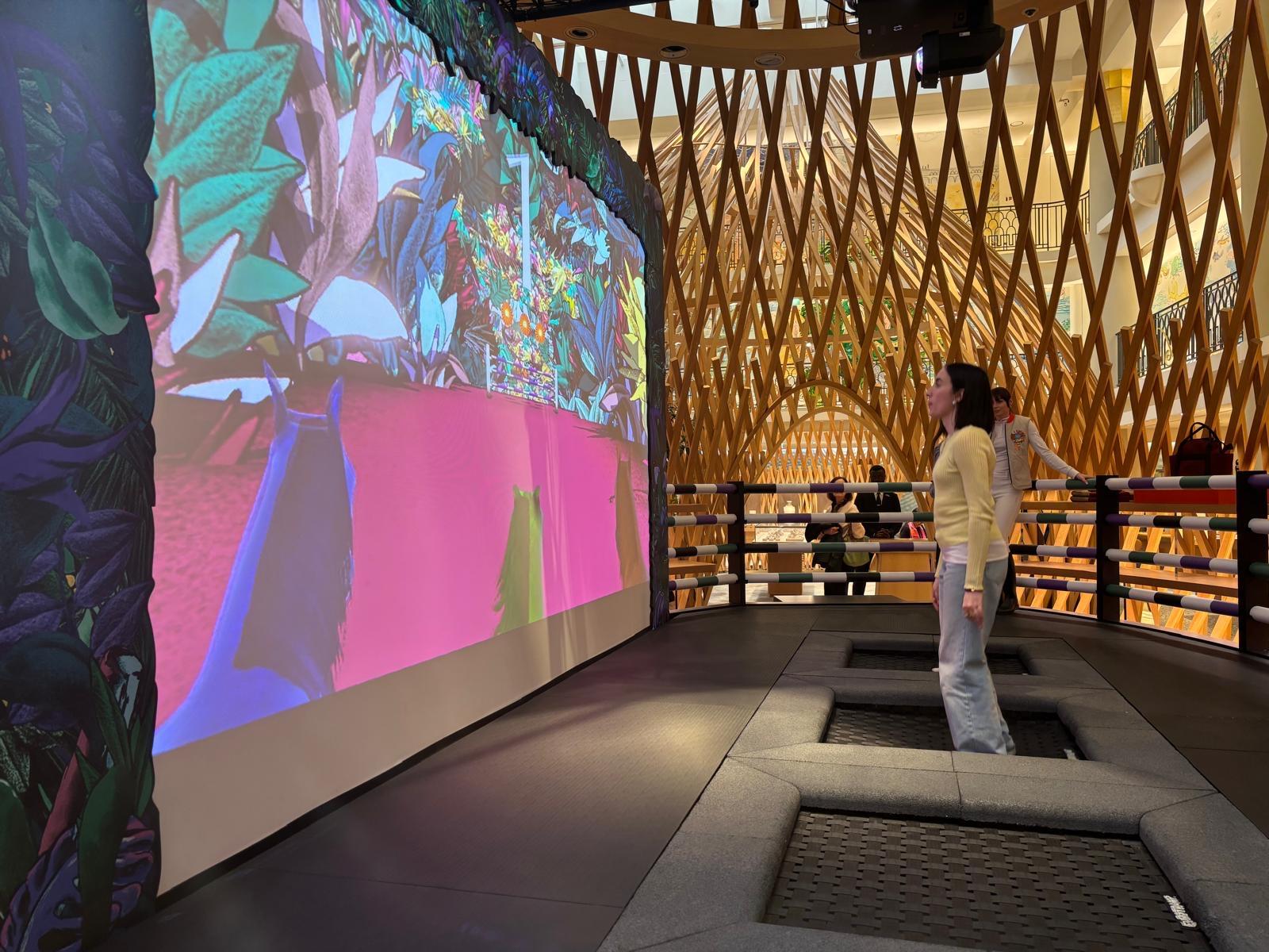 A person standing in a room with a large screenAI-generated content may be incorrect.