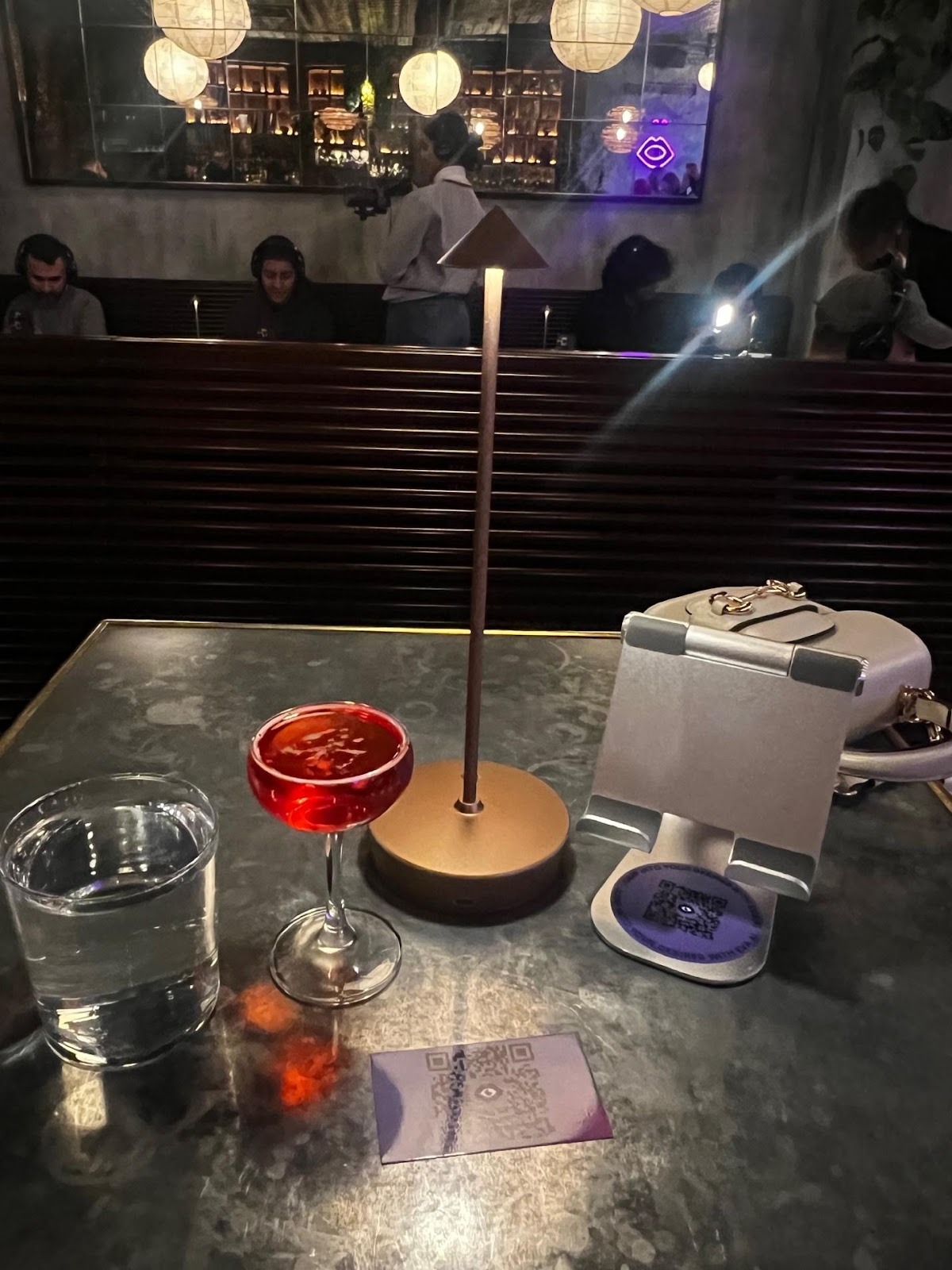 A table with a drink and a lampAI-generated content may be incorrect.