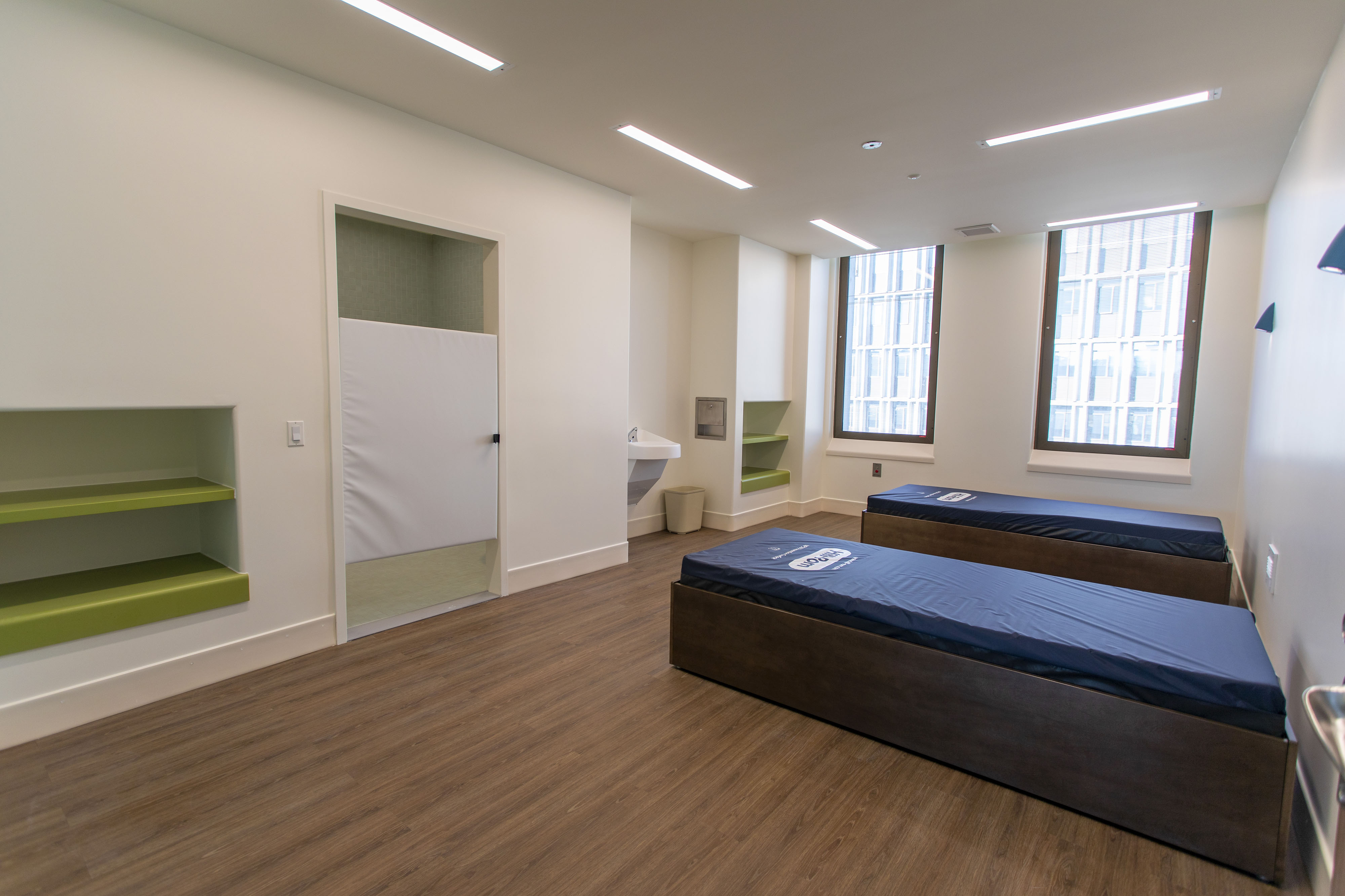 Sutter Health CPMC Davies Campus Behavioral Health Renovations, San Francisco: healthcare renovation by Herrero Builders in an occupied hospital, with OCULUS Architects. Interior view of a patient room with built-in shelving and impact-rated windows.