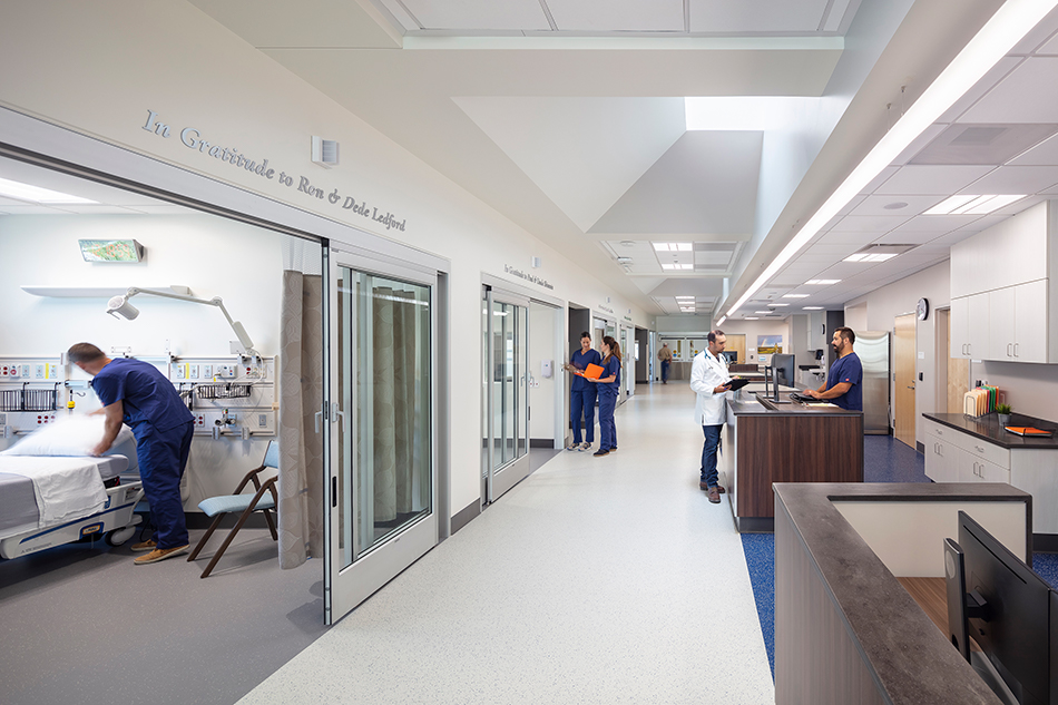 Adventist Health UVMC Ukiah Valley ED Expansion & ICU Addition, Ukiah, CA: Healthcare renovation, tenant improvement and new construction by Herrero Builders in an occupied environment, with Lionakis. Interior view of a corridor with patient rooms and a staff workstation.