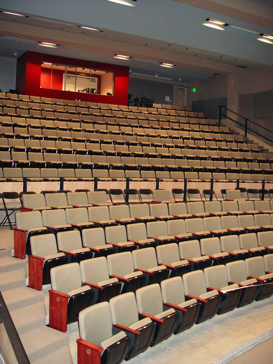 Schools of the Sacred Heart Siboni Arts & Science Center, San Francisco, CA: Education new construction by Herrero Builders with significant excavation, with Simon Martin-Vegue Winkelstein Moris. Interior view of a tiered auditorium with upholstered seats and a red control booth.