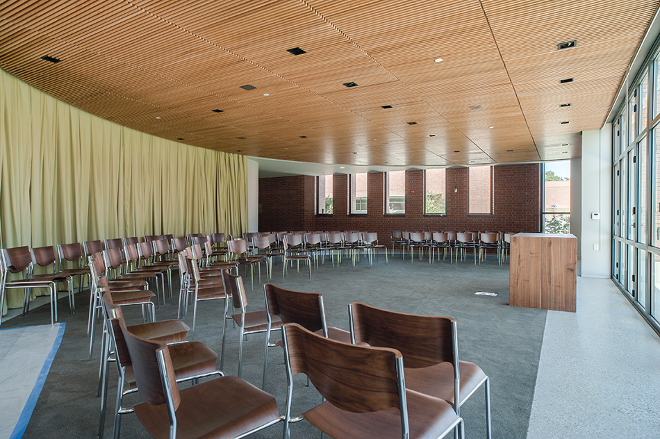 Sacred Heart Schools Atherton Lower & Middle School, Atherton, CA: Education new construction by Herrero Builders on a LEED Gold net zero energy campus, with WRNS Studio. Interior view of the assembly room from the side with a circular seating layout, a wood lectern and a glazed wall.