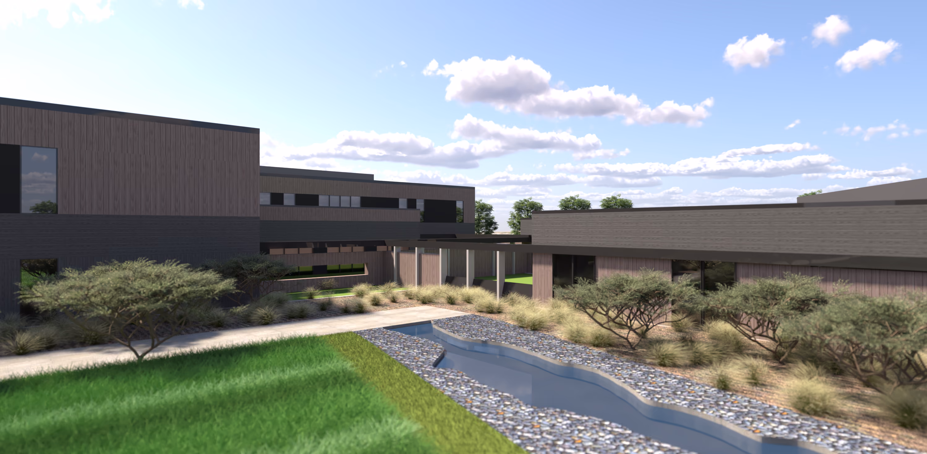 San Joaquin County BeWell Behavioral Health Campus, French Camp, CA: Healthcare new construction by Herrero Builders under Progressive Design Build, with kmd architects. Exterior view of a landscaped courtyard with a lawn, a gravel swale and desert plantings beside the buildings in a rendering.