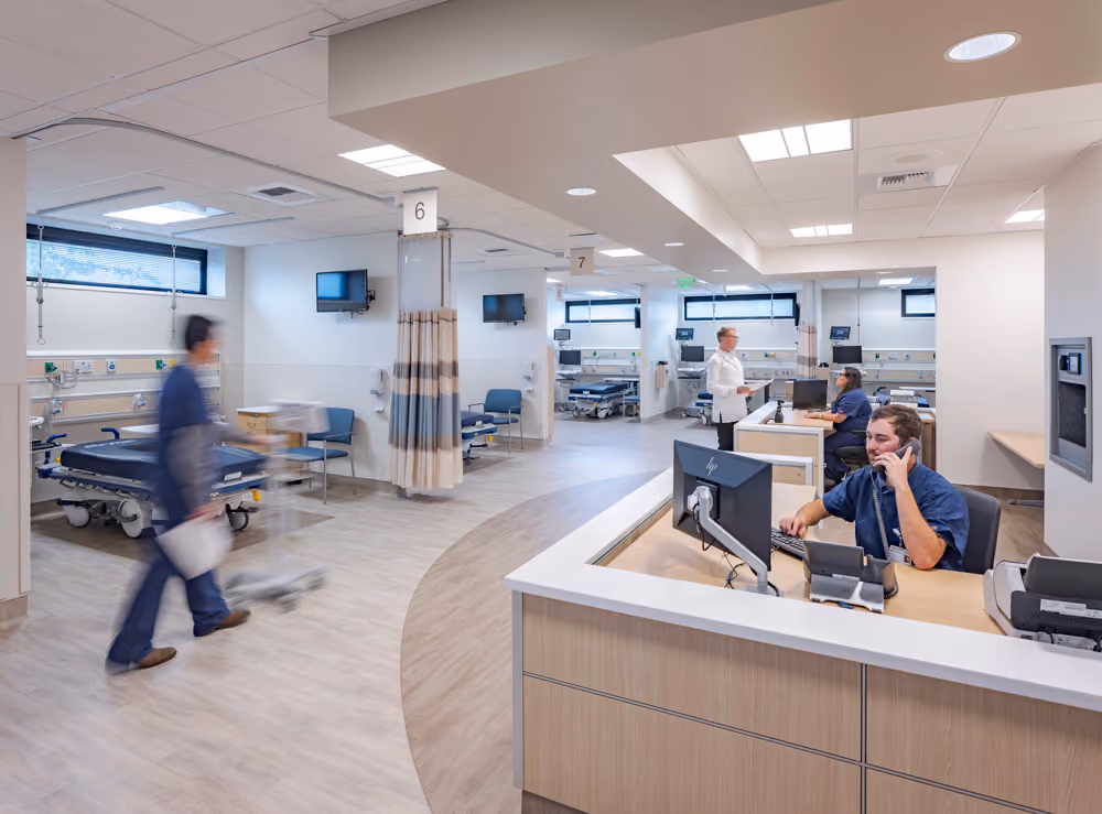 Sutter Health Santa Rosa Regional Hospital Expansion, Santa Rosa, CA: Healthcare New Construction by Herrero Builders under Integrated Project Delivery with Lean construction, with Stantec. Interior view of a patient care unit with a curved staff station, numbered bays and staff at work.