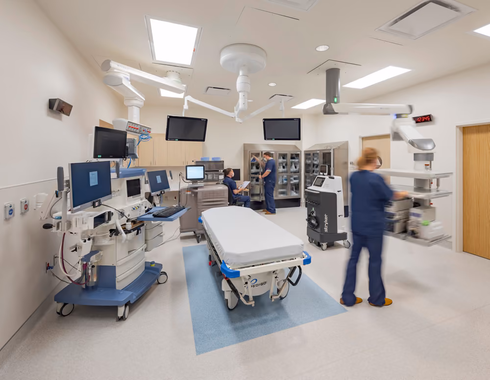 Sutter Health Santa Rosa Regional Hospital Expansion, Santa Rosa, CA: Healthcare New Construction by Herrero Builders under Integrated Project Delivery with Lean construction, with Stantec. Interior view of a procedure room with an endoscopy cart, monitors, ceiling-mounted booms and a gurney.