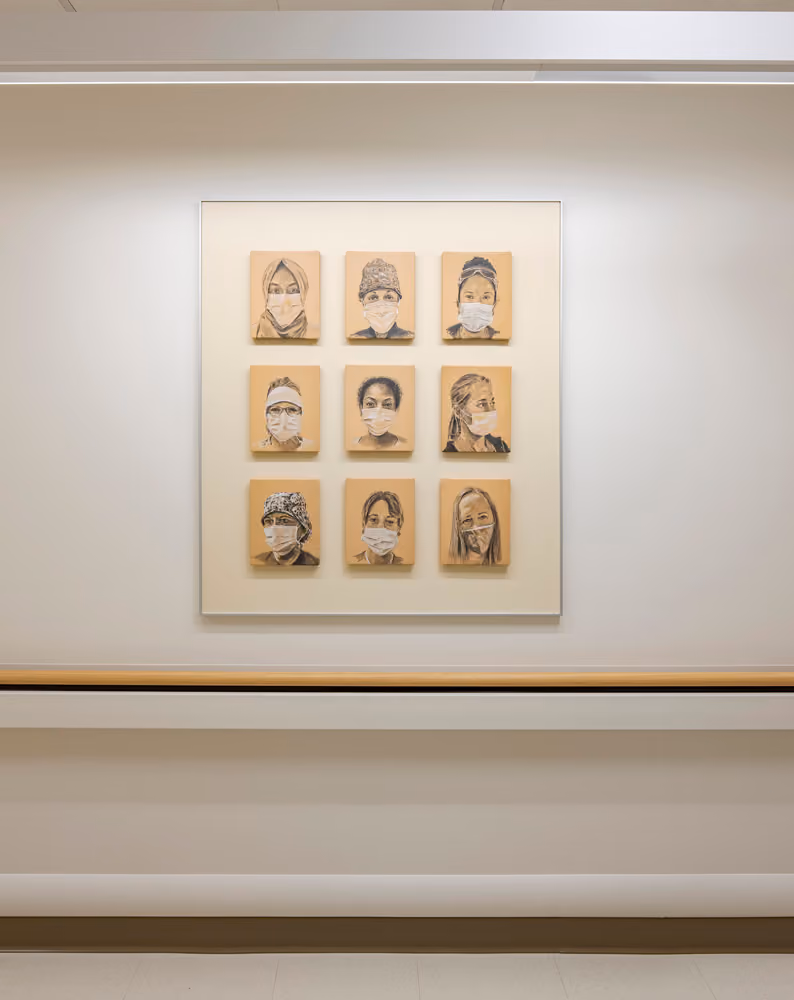 Sutter Health Santa Rosa Regional Hospital Expansion, Santa Rosa, CA: Healthcare New Construction by Herrero Builders under Integrated Project Delivery with Lean construction, with Stantec. Detail of a framed grid of nine portrait drawings of masked people on a hospital wall.