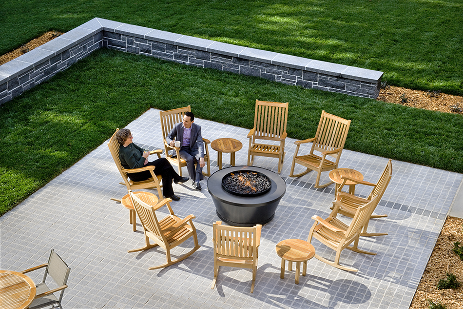 The Presidio Trust Inn at the Presidio, San Francisco, CA: Hospitality and Historic renovation by Herrero Builders preserving a National Historic Landmark, with Architectural Resources Group. Aerial view of a fire pit patio surrounded by rocking chairs, lawn and a stone wall.