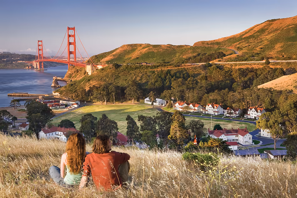 Fort Baker Retreat Group Cavallo Point Lodge & Spa, Sausalito, CA: Hospitality renovation and new construction by Herrero Builders in a historic landmark, with Leddy Maytum Stacy Architectural Resources Group. Site view of white historic buildings below hills with the Golden Gate Bridge beyond.