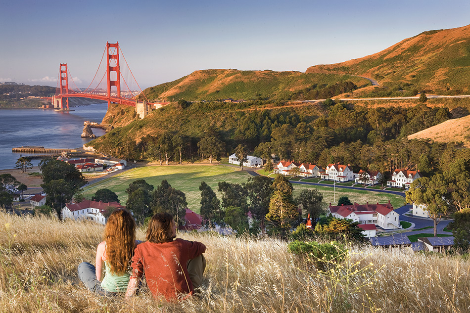 Fort Baker Retreat Group Cavallo Point Lodge & Spa, Sausalito, CA: Hospitality renovation and new construction by Herrero Builders in a historic landmark, with Leddy Maytum Stacy Architectural Resources Group. Site view of white historic buildings below hills with the Golden Gate Bridge beyond.
