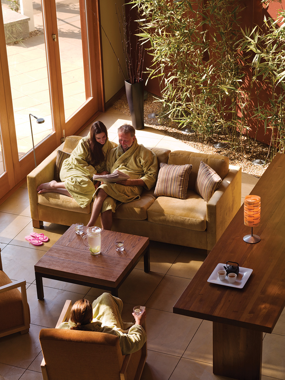 Fort Baker Retreat Group Cavallo Point Lodge & Spa, Sausalito, CA: Hospitality renovation and new construction by Herrero Builders in a historic landmark, with Leddy Maytum Stacy Architectural Resources Group. Interior view of a relaxation room with a sofa, bamboo planter and tall windows.