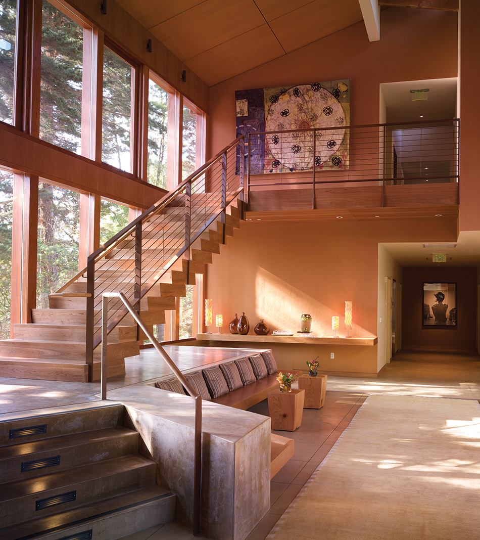 Fort Baker Retreat Group Cavallo Point Lodge & Spa, Sausalito, CA: Hospitality renovation and new construction by Herrero Builders in a historic landmark, with Leddy Maytum Stacy Architectural Resources Group. Interior view of a wood staircase beside a glazed wall and a seating alcove.