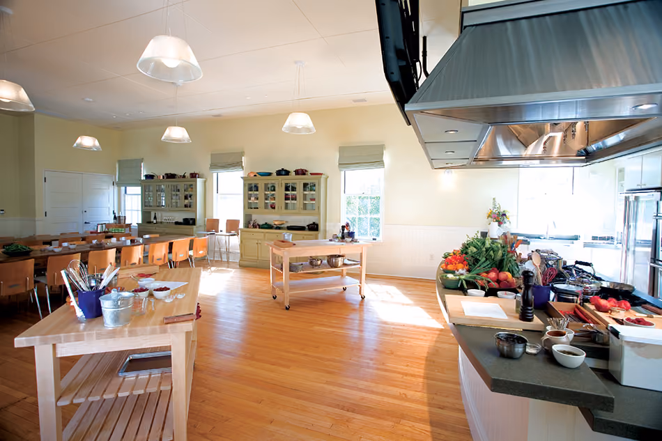 Fort Baker Retreat Group Cavallo Point Lodge & Spa, Sausalito, CA: Hospitality renovation and new construction by Herrero Builders in a historic landmark, with Leddy Maytum Stacy Architectural Resources Group. Interior view of a teaching kitchen with butcher-block islands and a range hood.